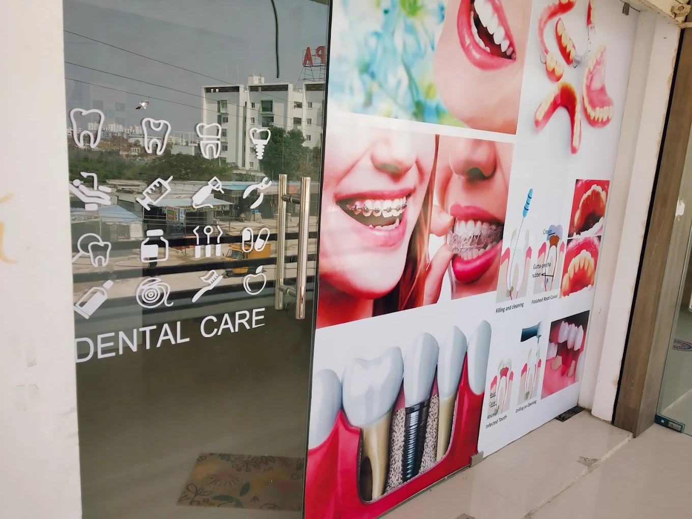 Glass entrance at Smile Tree Dental Clinic with dental-care graphics beside the door.