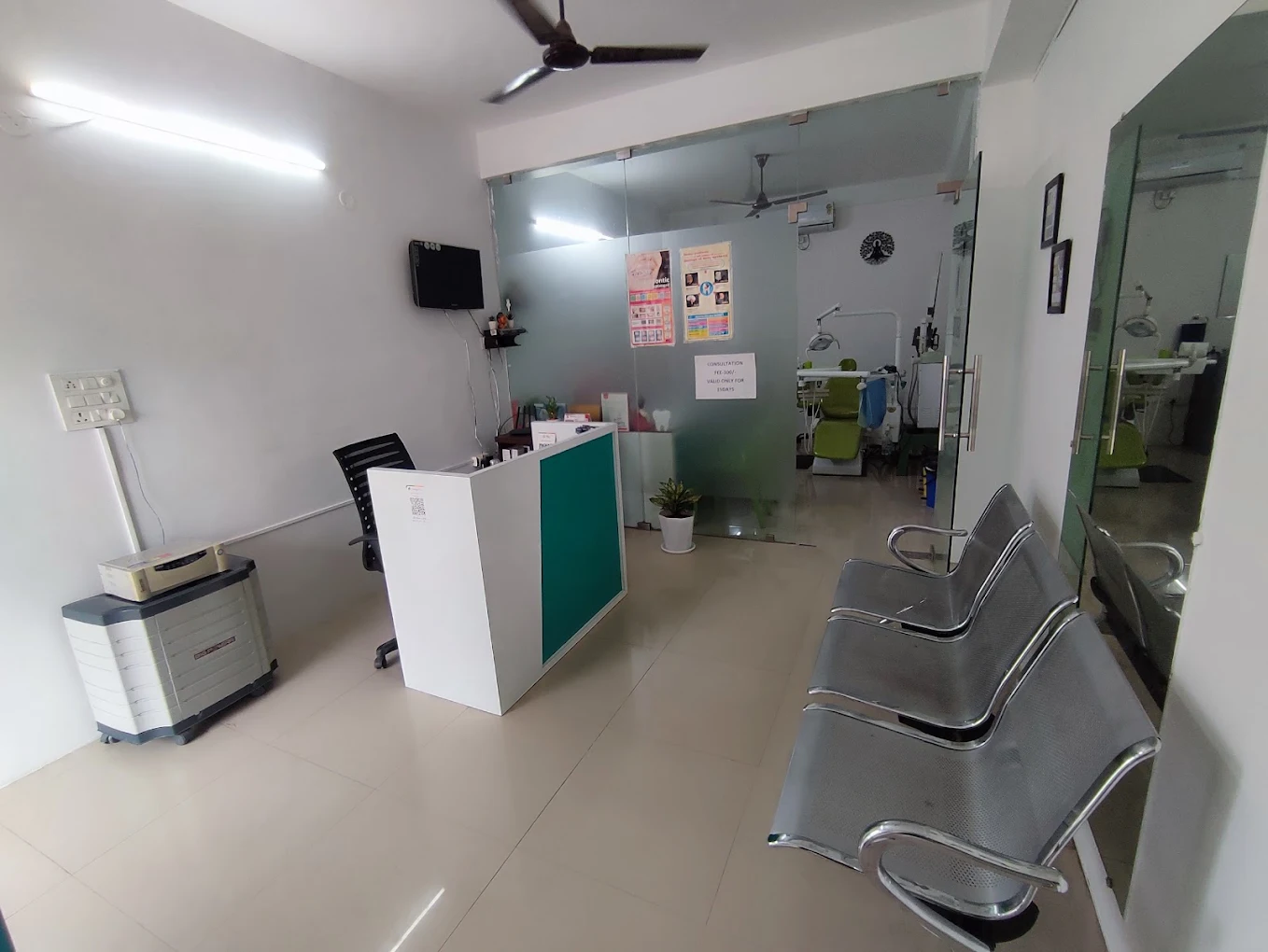 Reception desk, waiting chairs and treatment rooms at Smile Tree Dental Clinic.